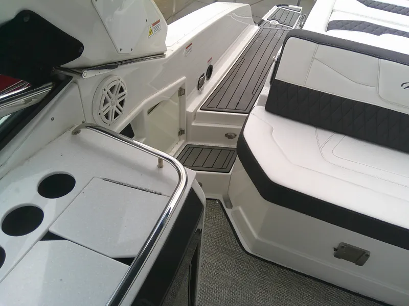 Slide: The Image of 2020 Monterey 305 Super Sport boat interior with seating and cup holders. - 18