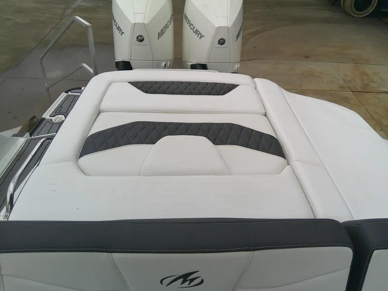 Slide: The Image of 2020 Monterey 305 Super Sport boat with white and gray seating, featuring Mercury engines. - 20