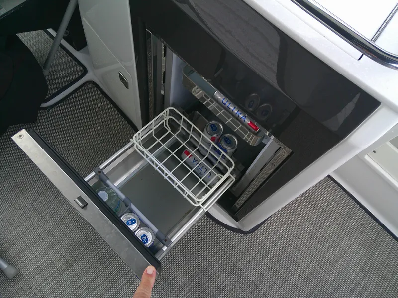 Slide: The Image of Open mini fridge on 2020 Monterey 305 Super Sport boat with drinks inside. - 23