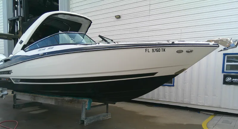Slide: The Image of 2020 Monterey 305 Super Sport boat in storage, white and black exterior. - 33