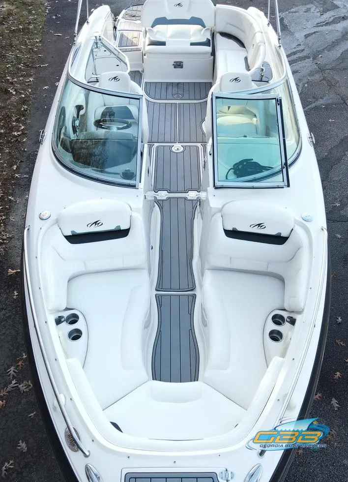 Slide: The Image of 2013 Monterey 264FS boat with sleek white interior and spacious seating. - 10
