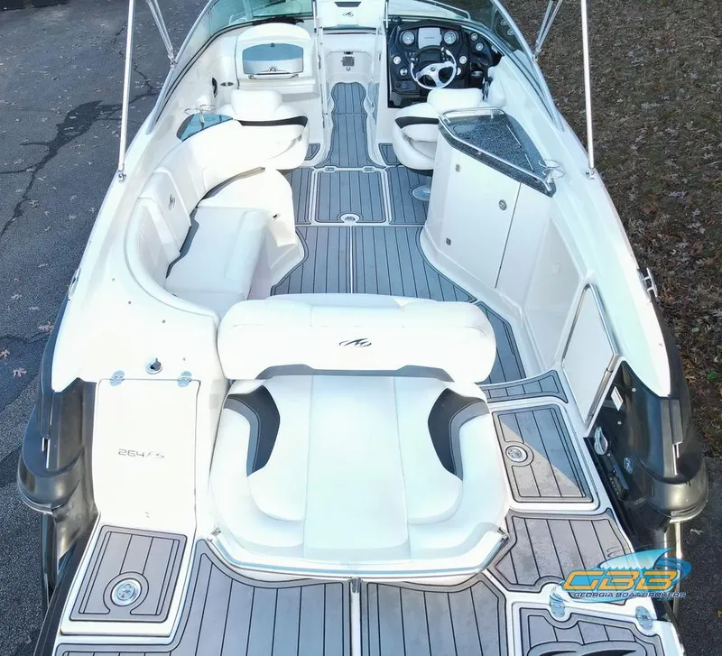 Slide: The Image of 2013 Monterey 264FS boat interior with white seating and sleek design. - 11