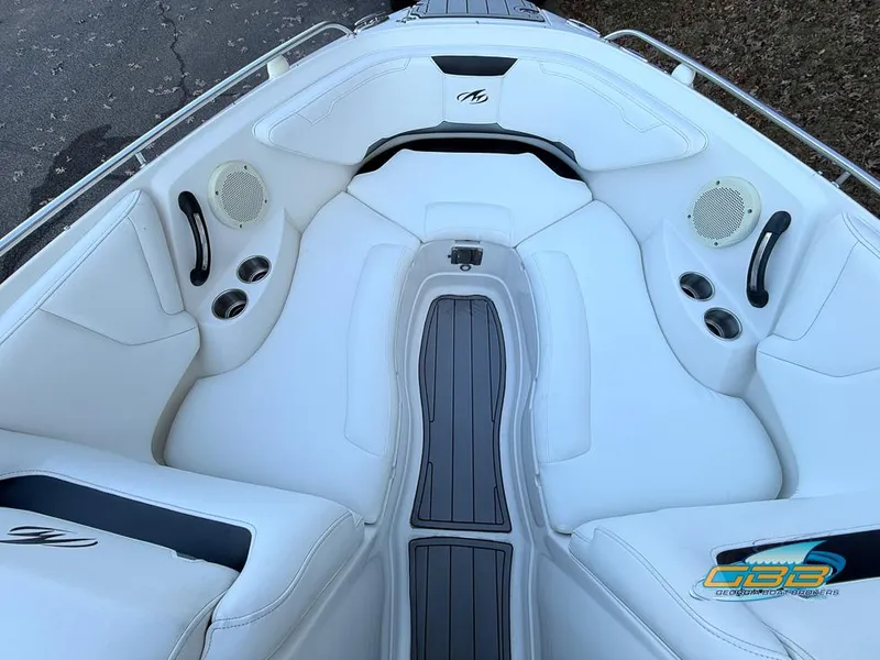 Slide: The Image of 2013 Monterey 264FS boat interior with white seating and cup holders. - 12