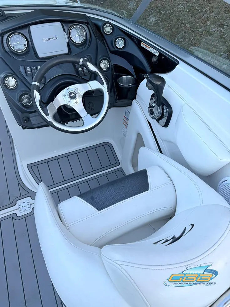 Slide: The Image of 2013 Monterey 264FS boat cockpit with steering wheel and control panel. - 17