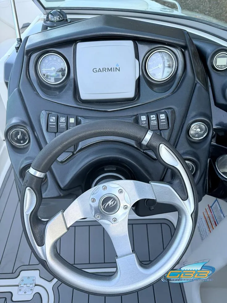Slide: The Image of 2013 Monterey 264FS boat dashboard with Garmin navigation system and steering wheel. - 18