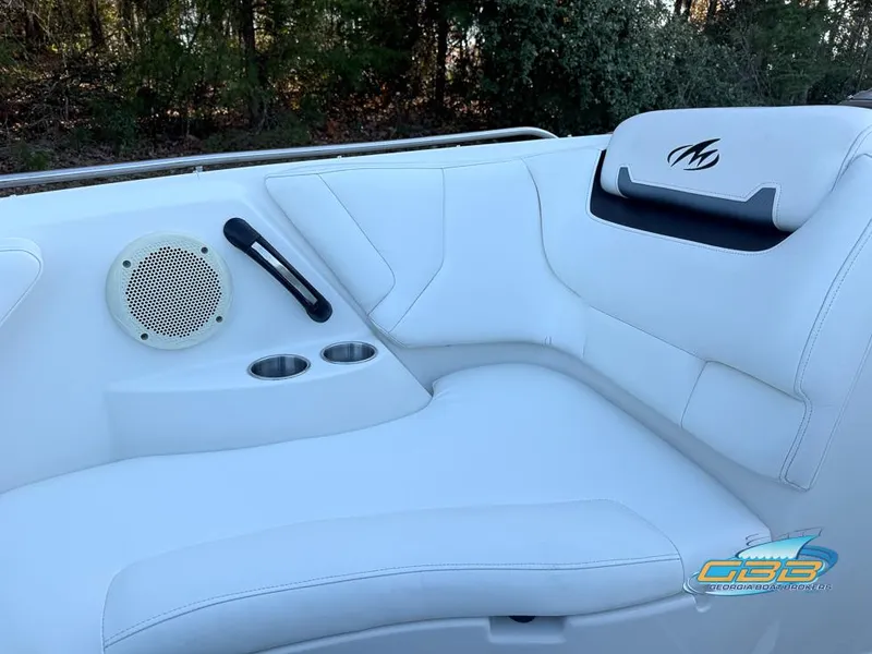 Slide: The Image of 2013 Monterey 264FS boat interior with white seating, speaker, and cup holders. - 23
