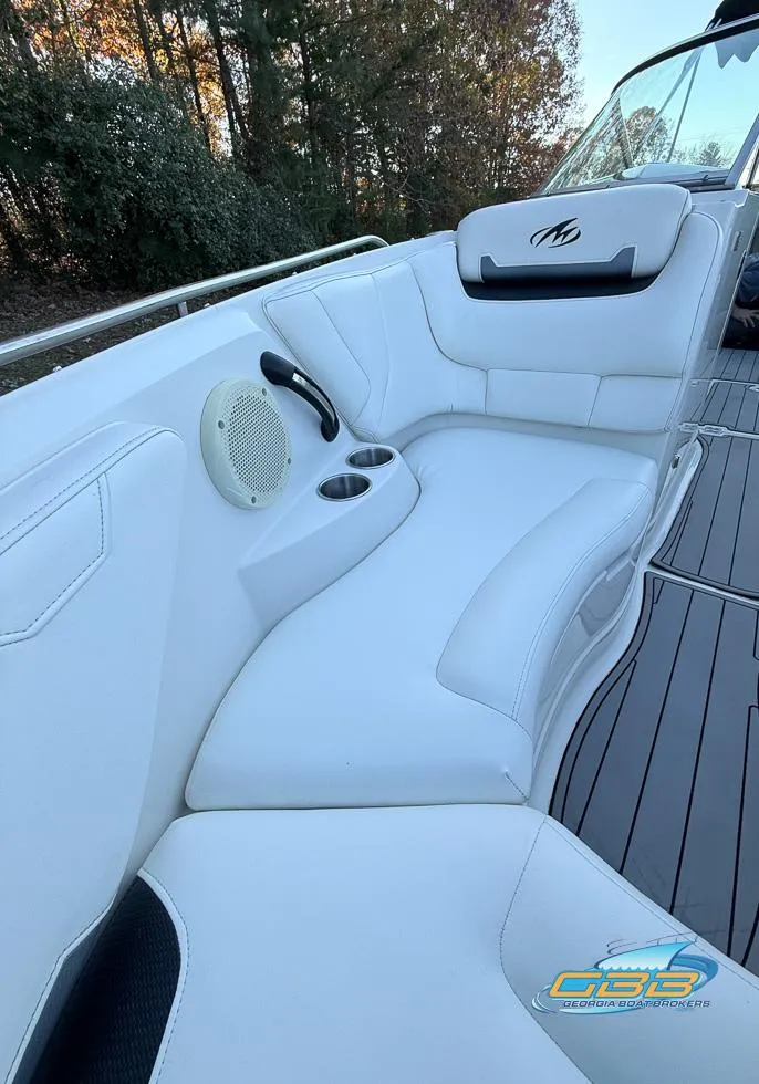 Slide: The Image of 2013 Monterey 264FS boat interior with white seating and cup holders. - 25