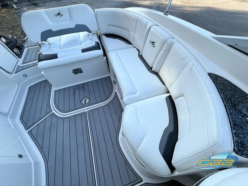 Slide: The Image of 2013 Monterey 264FS boat interior with white seating and gray flooring. - 26