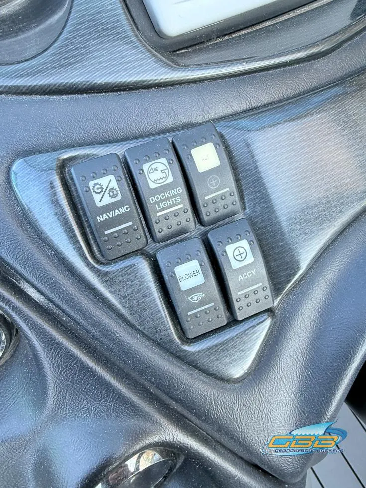 Slide: The Image of Control panel of a 2013 Monterey 264FS boat with various switches. - 32