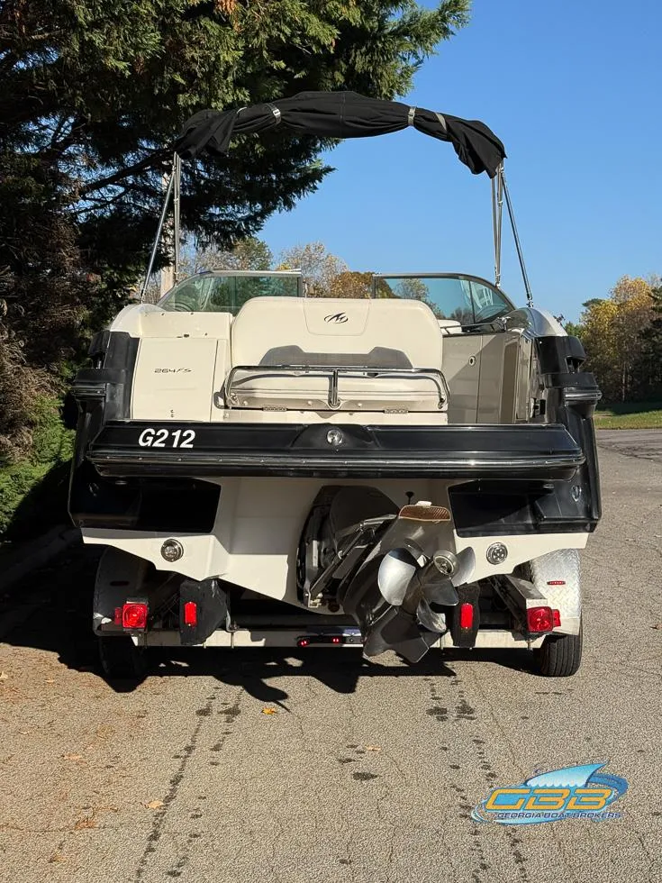 Slide: The Image of 2013 Monterey 264FS boat, rear view, parked on a sunny street. - 9