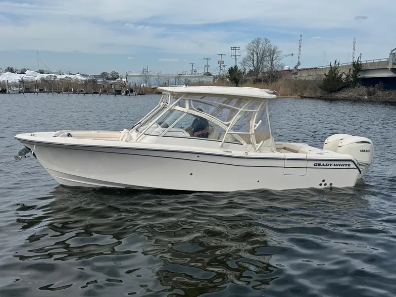 Slide: The Image of 2025 Grady-White Freedom 285 boat on calm water, side view. - 1