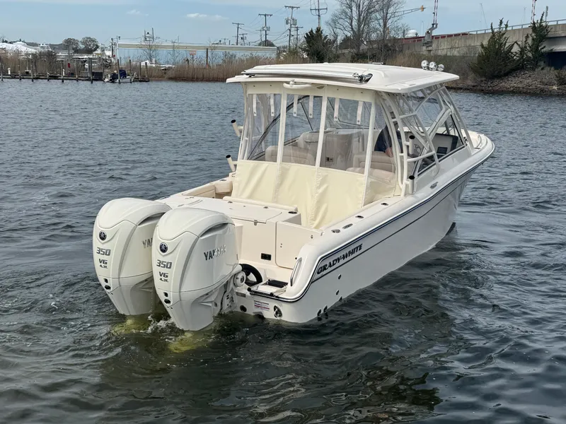 Slide: The Image of 2025 Grady-White Freedom 285 boat with twin Yamaha 350 engines on the water. - 10