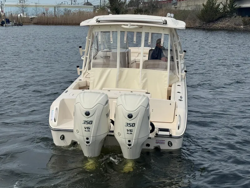 Slide: The Image of 2025 Grady-White Freedom 285 boat with twin 350 V6 engines on the water. - 11