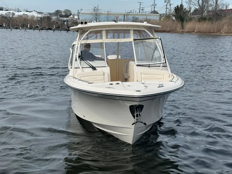 Slide: The Image of 2025 Grady-White Freedom 285 boat cruising on a calm waterway. - 12