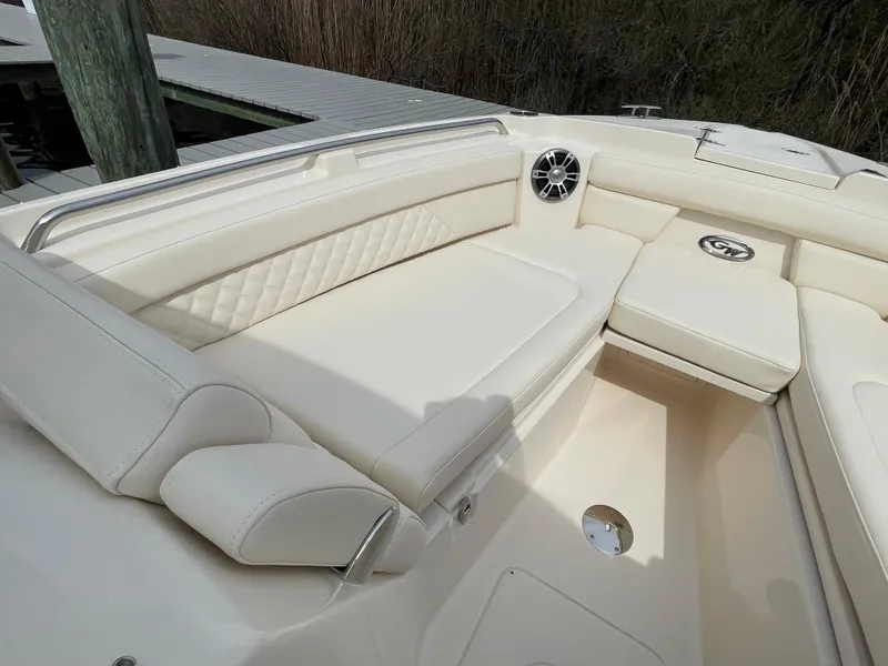 Slide: The Image of 2025 Grady-White Freedom 285 boat interior with cream seating and speaker. - 14