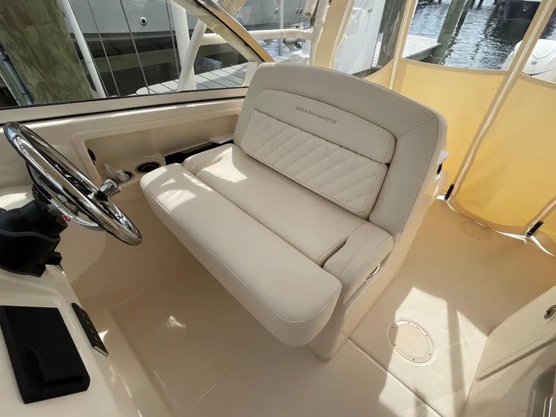 Slide: The Image of 2025 Grady-White Freedom 285 boat interior with luxurious seating and steering wheel. - 18