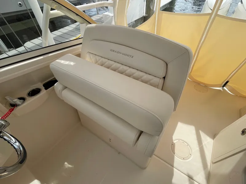 Slide: The Image of 2025 Grady-White Freedom 285 boat interior with beige seating and cup holders. - 19