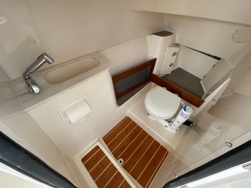 Slide: The Image of 2025 Grady-White Freedom 285 boat bathroom with sink, toilet, and wooden flooring. - 20