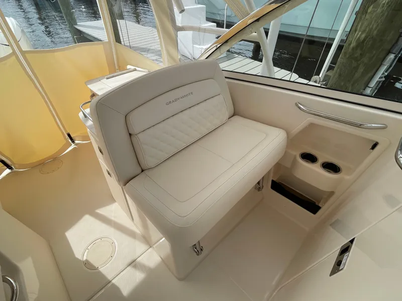 Slide: The Image of 2025 Grady-White Freedom 285 boat interior with beige seating and cup holders. - 22