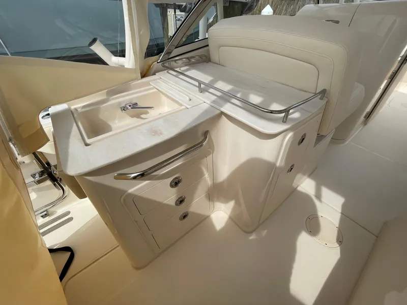 Slide: The Image of 2025 Grady-White Freedom 285 boat interior with sink and storage area. - 23