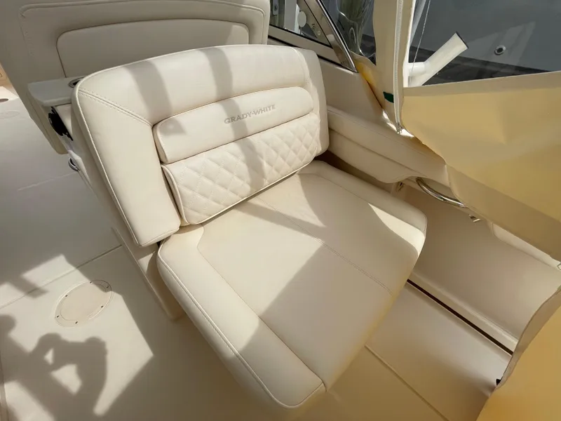 Slide: The Image of 2025 Grady-White Freedom 285 boat interior with beige seating and elegant design. - 24