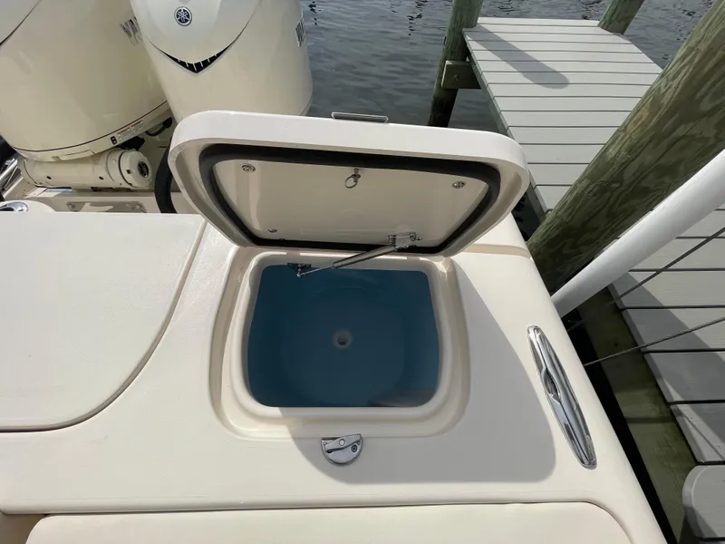 Slide: The Image of Open storage compartment on 2025 Grady-White Freedom 285 boat near dock. - 26