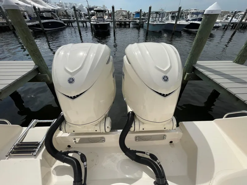 Slide: The Image of 2025 Grady-White Freedom 285 boat with twin outboard engines at a marina dock. - 27