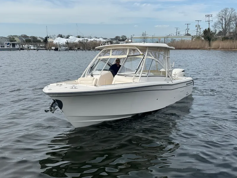 Slide: The Image of 2025 Grady-White Freedom 285 boat cruising on calm waters. - 3