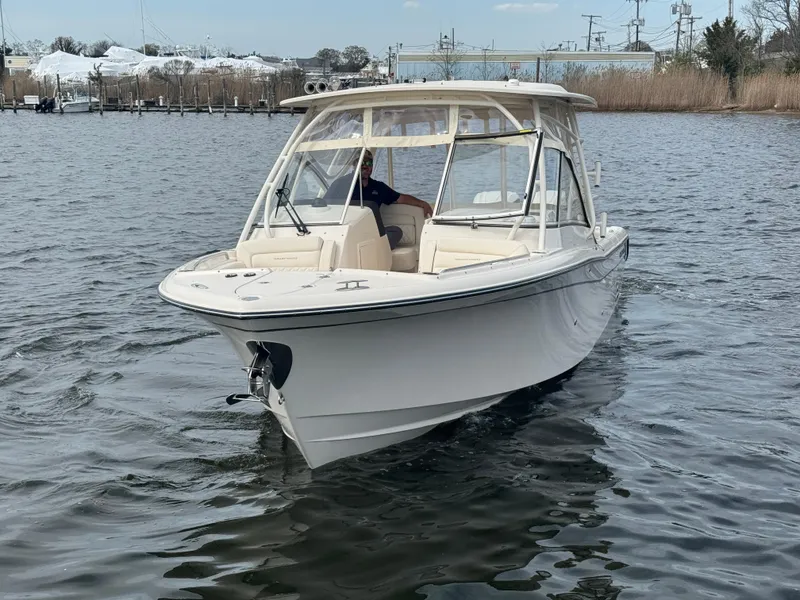 Slide: The Image of 2025 Grady-White Freedom 285 boat cruising on a calm waterway. - 5