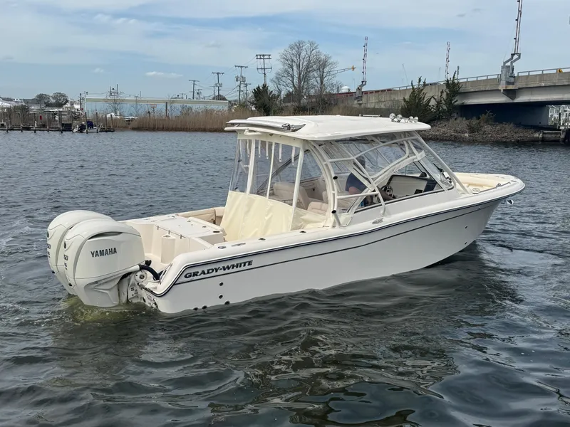 Slide: The Image of 2025 Grady-White Freedom 285 boat with Yamaha engines on a calm waterway. - 8
