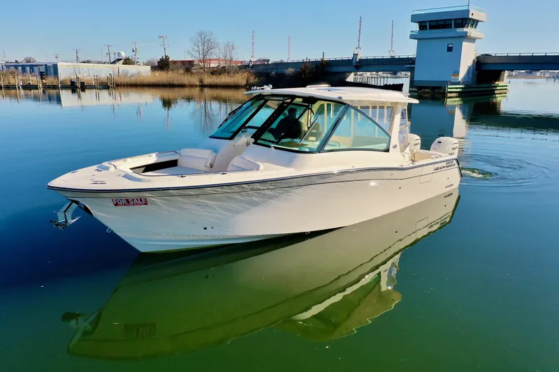 Slide: The Image of 2025 Grady-White Freedom 345 boat on calm water near a bridge. - 10