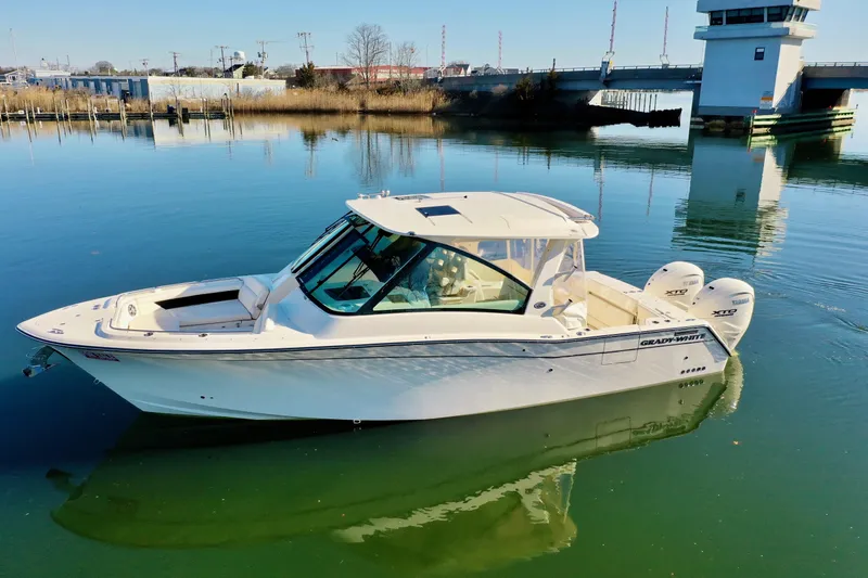 Slide: The Image of 2025 Grady-White Freedom 345 boat on calm water, side view. - 13
