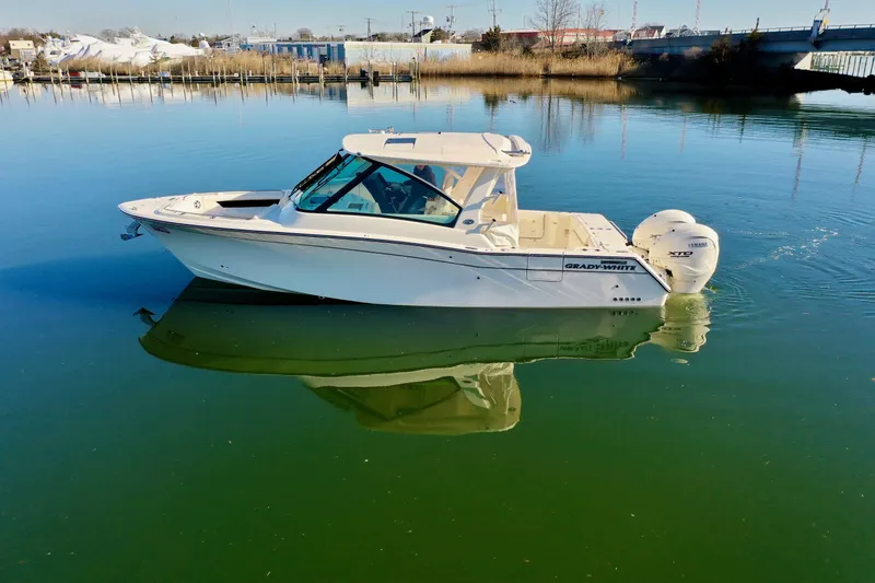 Slide: The Image of 2025 Grady-White Freedom 345 boat on calm water, side view. - 15