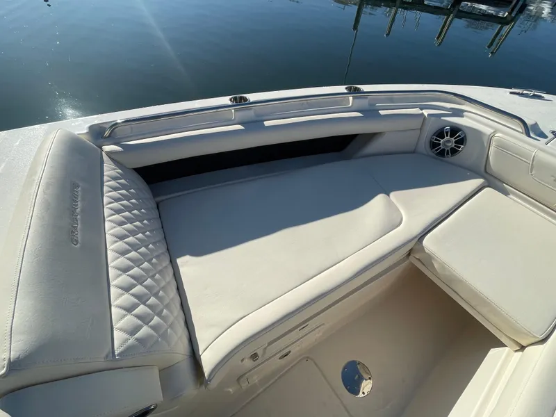 Slide: The Image of 2025 Grady-White Freedom 345 boat interior with cushioned seating and speaker. - 19