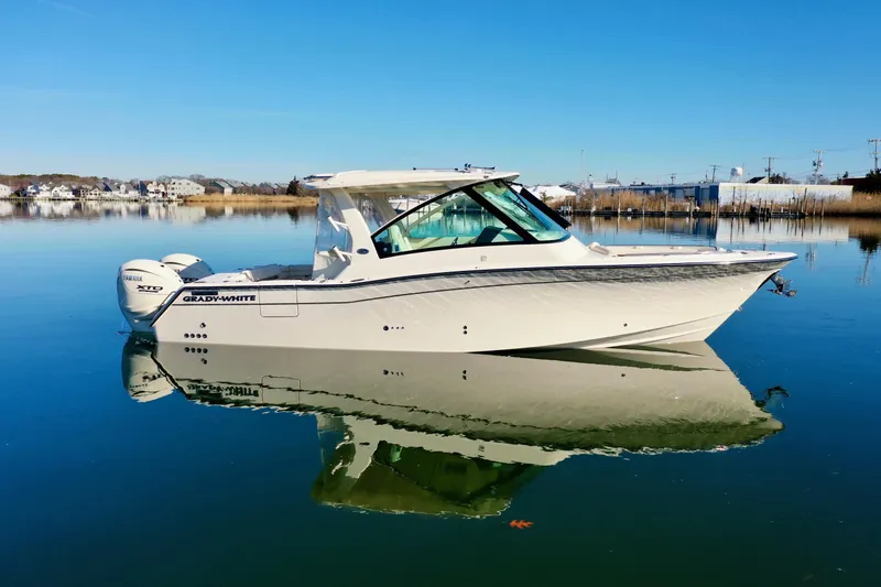 Slide: The Image of 2025 Grady-White Freedom 345 boat on calm water, clear sky background. - 2