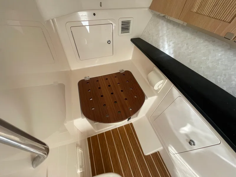 Slide: The Image of 2025 Grady-White Freedom 345 interior with wooden seat and modern cabinetry. - 27