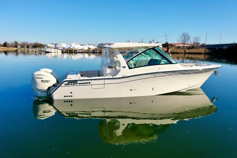 Slide: The Image of 2025 Grady-White Freedom 345 boat on calm water, side view. - 3