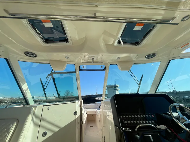 Slide: The Image of 2025 Grady-White Freedom 345 boat interior with modern dashboard and panoramic windows. - 30