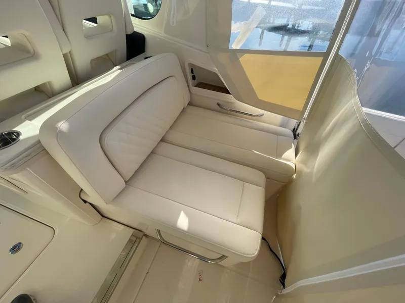 Slide: The Image of 2025 Grady-White Freedom 345 boat interior with beige seating and modern design. - 34