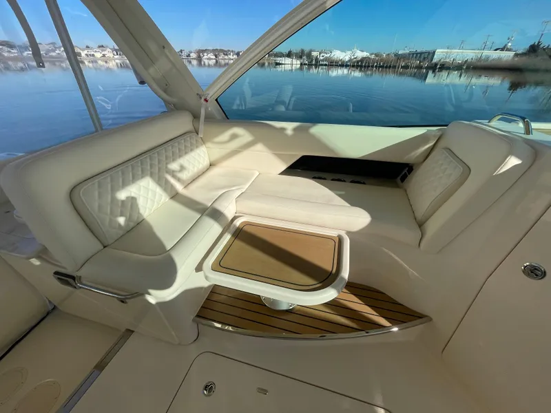 Slide: The Image of 2025 Grady-White Freedom 345 boat interior with luxurious seating and scenic water view. - 35
