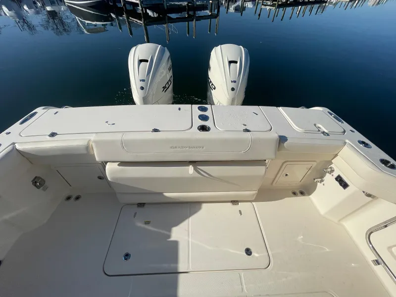 Slide: The Image of 2025 Grady-White Freedom 345 boat with dual engines, docked on calm water. - 41