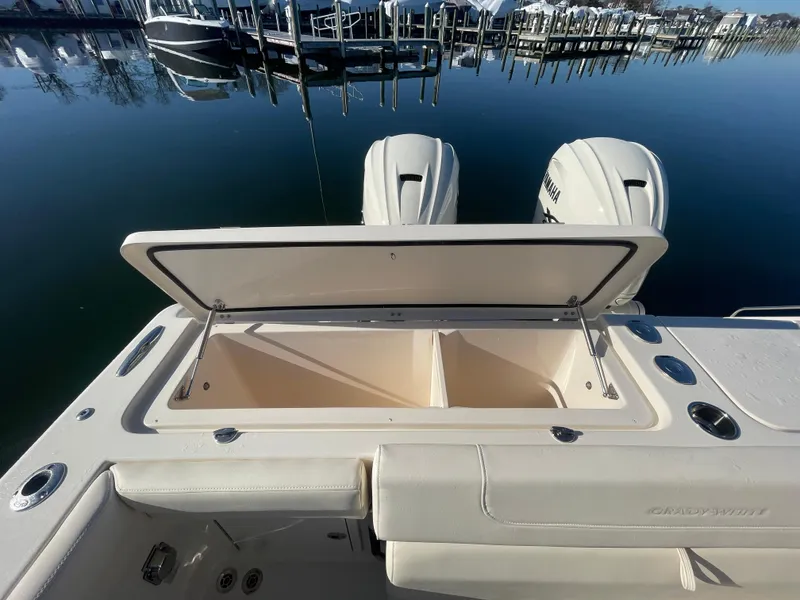 Slide: The Image of 2025 Grady-White Freedom 345 boat with open storage compartment and twin engines. - 42