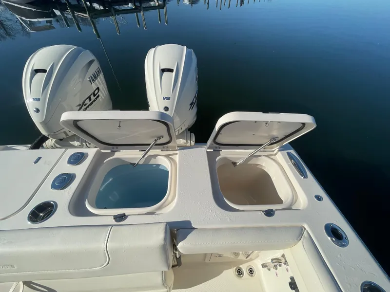 Slide: The Image of 2025 Grady-White Freedom 345 boat with open storage compartments and twin Yamaha engines. - 43