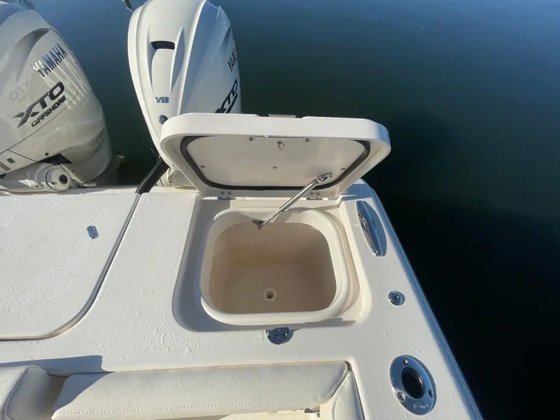 Slide: The Image of 2025 Grady-White Freedom 345 boat with open storage compartment and dual outboard engines. - 44