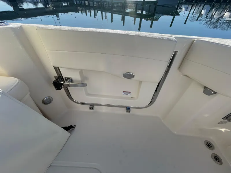Slide: The Image of 2025 Grady-White Freedom 345 boat interior, featuring a sleek white door and chrome accents. - 46
