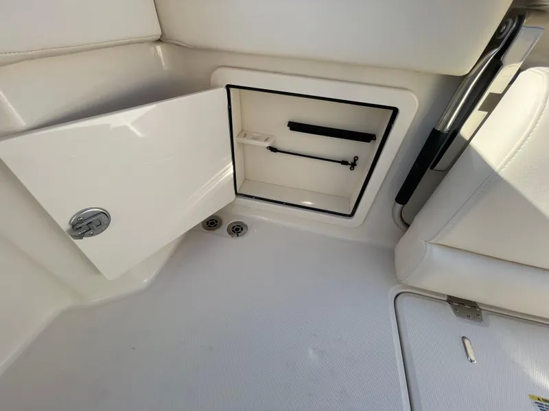 Slide: The Image of 2025 Grady-White Freedom 345 boat storage compartment with open door, showcasing interior space. - 47