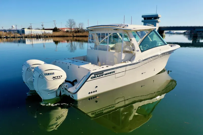 Slide: The Image of 2025 Grady-White Freedom 345 boat on calm water, featuring twin Yamaha XTO engines. - 5