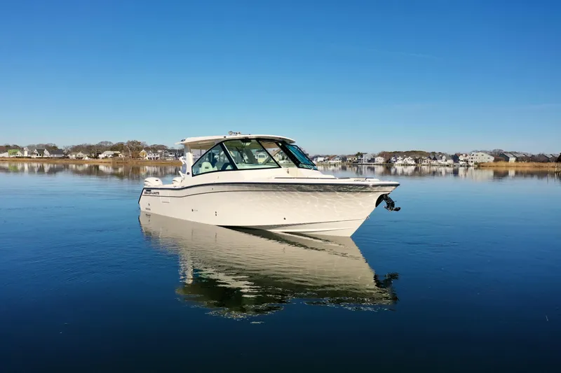 Slide: The Image of 2025 Grady-White Freedom 345 boat on calm water, clear blue sky background. - 7