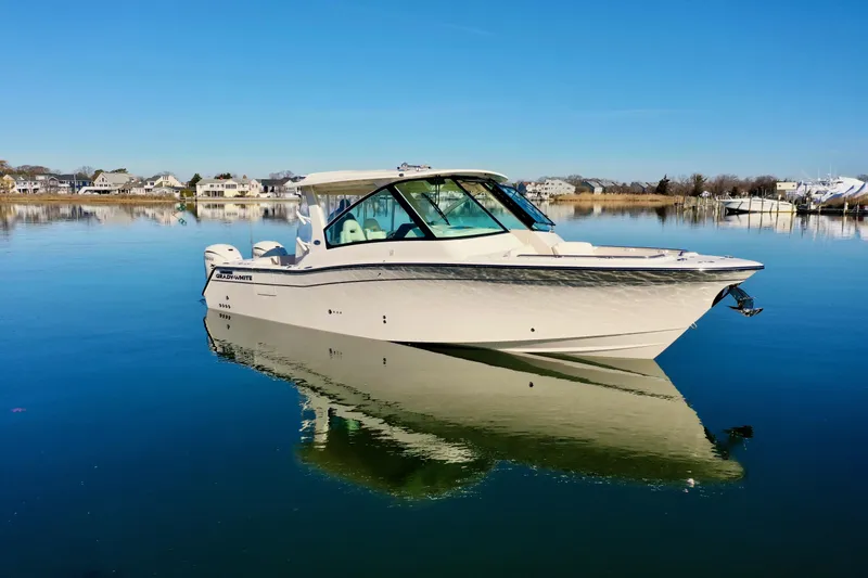 Slide: The Image of 2025 Grady-White Freedom 345 boat on calm water, clear sky background. - 8