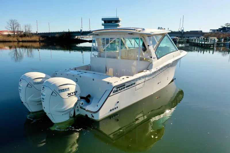 Slide: The Image of 2025 Grady-White Freedom 345 boat with twin Yamaha engines on calm water. - 9